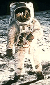 Aldrin on Moon with Armstrong reflected in helmet visor